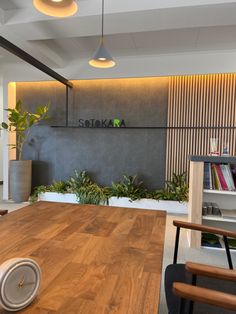 a wooden table sitting in front of a book shelf