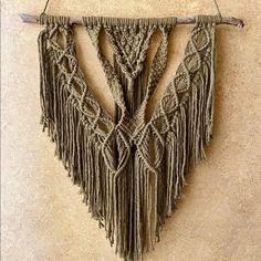 a wall hanging made out of macrame yarn