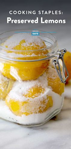 lemons and powdered sugar in a glass jar with the title cooking staples preserved lemons