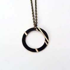 We might be biased, but circles are our favorite shape. This design is based around a snare drum rim / hoop, and makes for a simply yet meaningful design. Also, we're fans of circles and things coming full circle. Show your love for music with this reclaimed cymbal necklace. This piece is 1" in diameter. Looking for a smaller piece? Check out our Dark Hoop necklace which is 0.75" in diameter. - 18" Length Chain - choose from black or antique bronze (want a different length chain?     Just mention your desired length in the notes after adding this product to cart!) - 2" Chain extender included for length options - Cymbal piece is 1" x 1" - Reclaimed from broken cymbals made from bronze, painted black - Due to the reclaimed nature of the cymbals we use, each product is different. You may Hoop Necklace, Meaningful Design, Snare Drum, Chain Extenders, Upcycled Jewelry, Cymbals, Full Circle, Salt Lake City, Favorite Things Gift