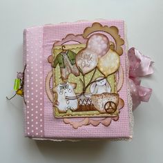 a pink and white box with some decorations on it