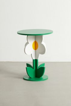 a green table with a flower cut out of it