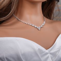 a woman wearing a diamond necklace and earrings