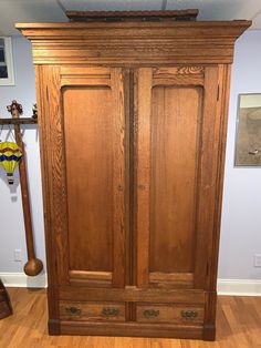 a large wooden armoire sitting on top of a hard wood floor