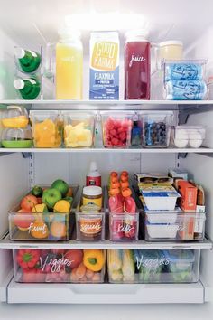 an open refrigerator filled with lots of different types of fruits and vegetables in plastic containers