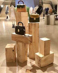 several pieces of wood stacked on top of each other with purses and handbags