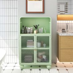 a green cabinet in a bathroom next to a sink