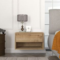 a nightstand with a lamp on top of it next to a chair