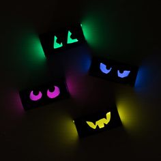 three boxes with glowing eyes on them in the dark