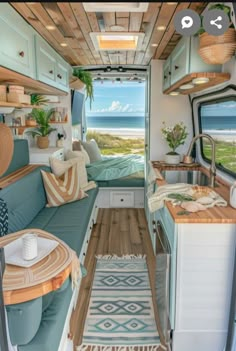 the interior of an rv with wood flooring and blue couches in front of it