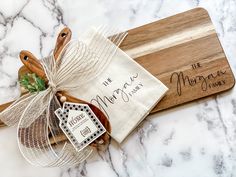 a wooden cutting board sitting on top of a white marble counter next to a bag