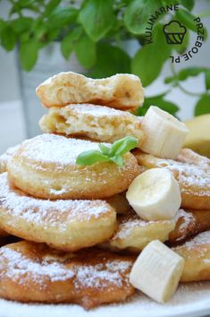 a pile of bananas and powdered sugar on a plate