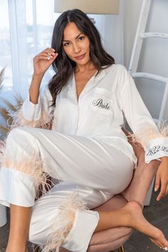 a woman sitting on top of a chair wearing white pajamas