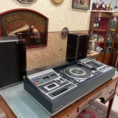 two turntables are sitting on top of a table in a room with other items