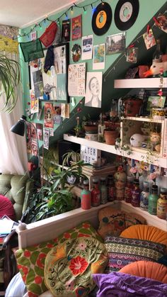 a room filled with lots of plants and pictures on the wall