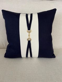 a black and white pillow sitting on top of a couch