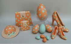 an assortment of orange and white polka dot shoes, hats, and other items are on display