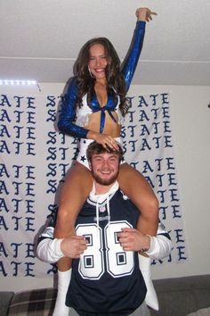 two cheerleaders are posing for the camera