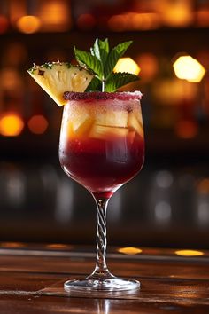 a glass filled with liquid and garnish on top of a wooden table