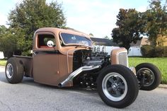 an old model truck is parked on the street