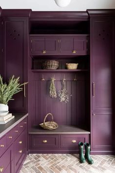 a purple closet with wooden cabinets and green rubber boots