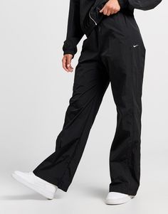 Add an essential to your rotation with these women's Woven Wide Leg Track Pants by Nike. In a Black colourway, these relaxed fit track pants are made with a water-repellent nylon fabric that provides UV protection so you can wear them whatever the weather. They feature an elastic waistband for a supportive feel, and snap pockets so you can secure your staples. Signed off with Nike branding to the leg. Machine washable. | Our model is 5'8" and wears a size small. Track Pants Nike, Track Outfits, Wide Leg Track Pants, Nike React Vision, 270 Nike, Nike Branding, Pants Nike, Leggings Hoodie, Woman Weaving