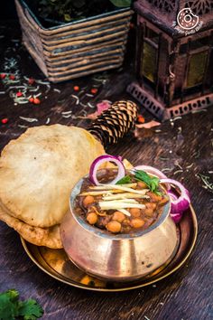 a plate with some food on top of it next to a pine cone and other items