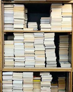 stacks of books are stacked on top of each other in a bookcase at the library