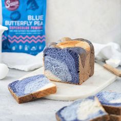 a loaf of blueberry bread sitting on top of a cutting board