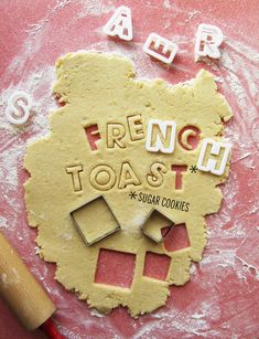 a cookie with the word french toast spelled in small letters on it next to a rolling pin