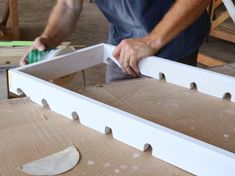 a man sanding down some pieces of wood