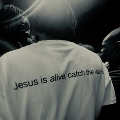 jesus is alive, catch the vision t - shirt on a man's back