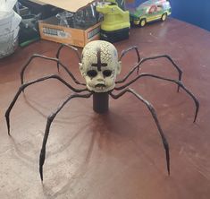 a fake spider with a cross on it's head sitting on top of a table