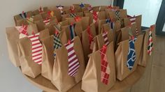 many bags with ties on them sitting on a table