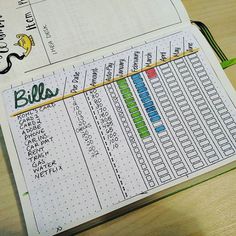 an open planner sitting on top of a wooden table