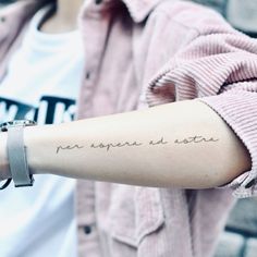 a woman with a tattoo on her arm saying home is where the heart is