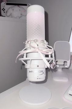 a white microphone sitting on top of a desk