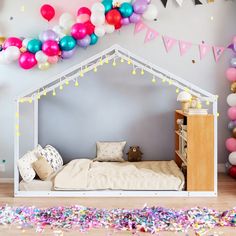 a child's bedroom with balloons and confetti