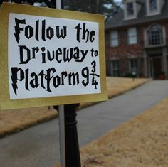 a sign that says follow the driveway to platform 9 4 on a pole in front of a house