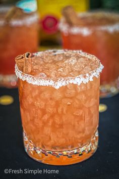 two cocktails sitting on top of a table next to each other