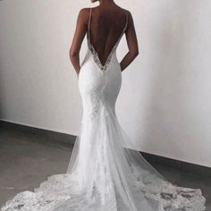 a woman in a white wedding dress looking back