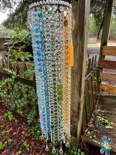 a colorful wind chime hanging from a tree