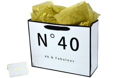 a white shopping bag with gold foil wrapped around it and the number 40 on it