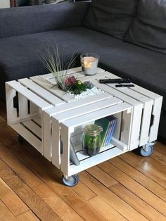 a coffee table made out of pallets with plants on top