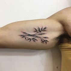 a man's arm with arrows tattoo on it