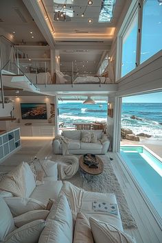 a living room filled with furniture next to the ocean