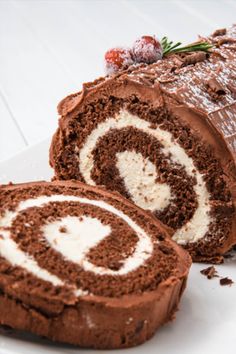 there is a chocolate roll with white frosting on the side and sprinkled with icing