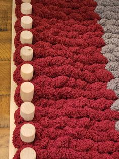 a red rug with white circles on it and several smaller ones in the middle next to each other