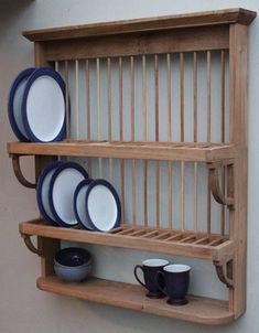 a wooden shelf with plates and cups on it