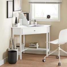 a white desk and chair in front of a window